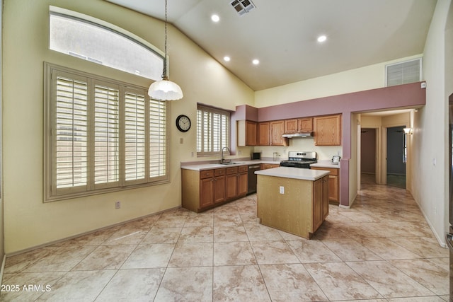 kitchen with light countertops, dishwasher, a sink, and visible vents
