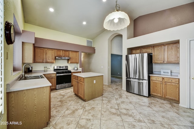 kitchen with visible vents, a center island, light countertops, a sink, and stainless steel appliances