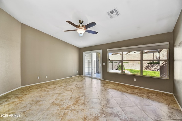 spare room with visible vents, baseboards, a ceiling fan, and lofted ceiling