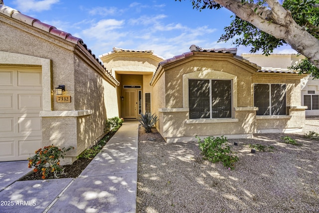 doorway to property with a tile roof and stucco siding
