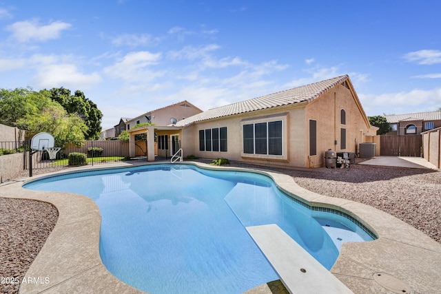 view of pool featuring a patio, a diving board, central air condition unit, and a fenced backyard