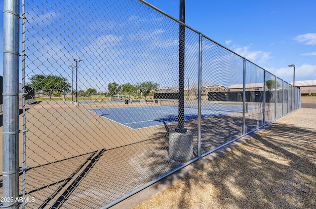view of tennis court with fence