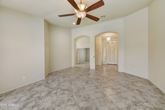 empty room featuring visible vents, ceiling fan, recessed lighting, and arched walkways