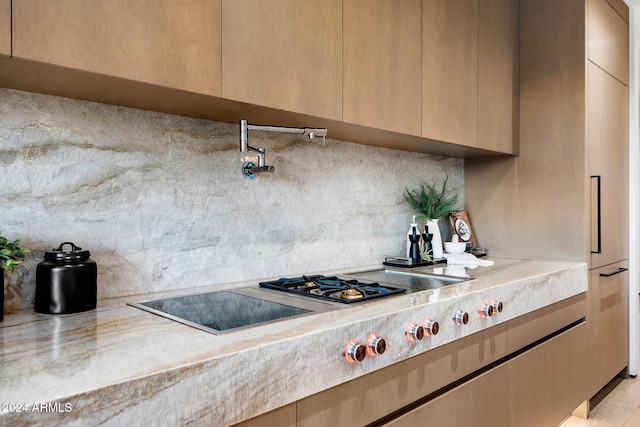 kitchen featuring light brown cabinetry and light hardwood / wood-style flooring