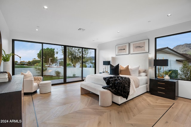 bedroom with access to exterior and light parquet floors