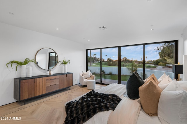 bedroom with a water view, access to exterior, and light parquet floors