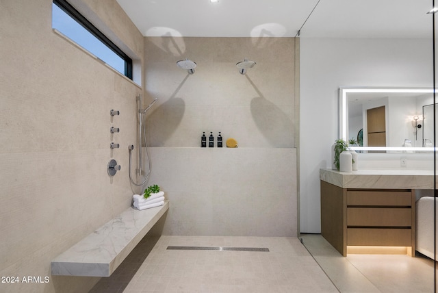 bathroom with tile patterned floors, vanity, and a shower