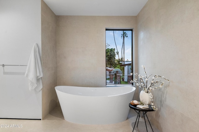 bathroom featuring a bathtub and tile walls