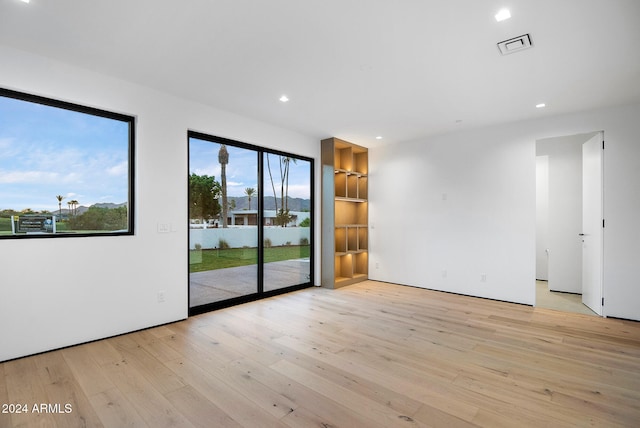 unfurnished room featuring light hardwood / wood-style floors