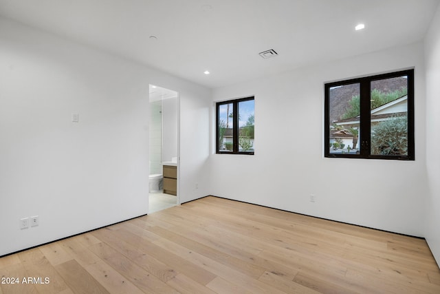 empty room with plenty of natural light and light wood-type flooring