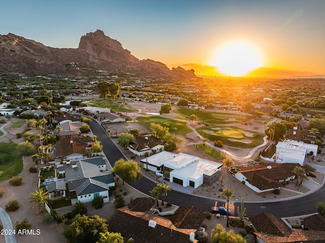 aerial view at dusk featuring a mountain view