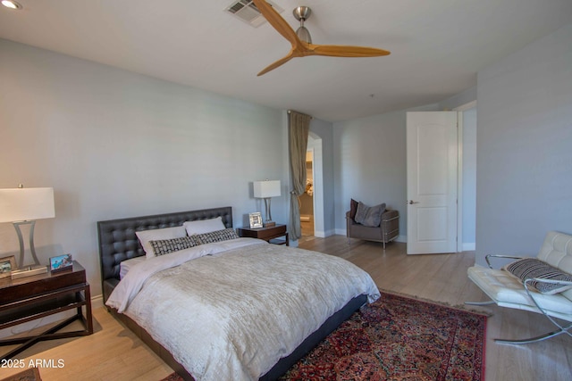 10655 N 9th St Unit 112, Phoenix, AZ 85020 - bedroom featuring wood finished floors, a ceiling fan, and arched walkways