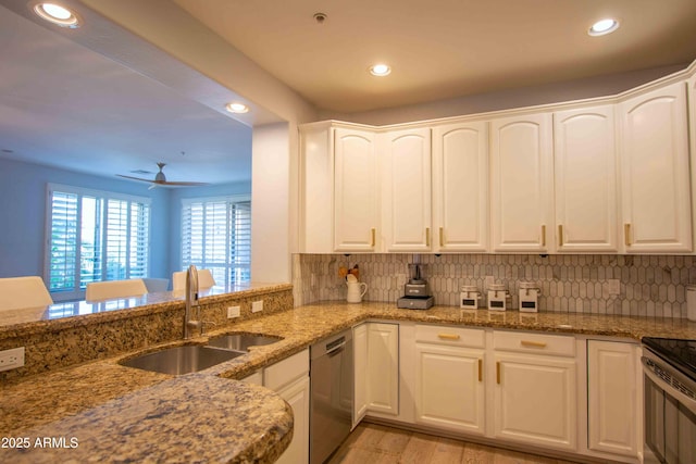 10655 N 9th St Unit 112, Phoenix, AZ 85020 - kitchen featuring stainless steel appliances, recessed lighting, light wood-type flooring, light stone countertops, and backsplash