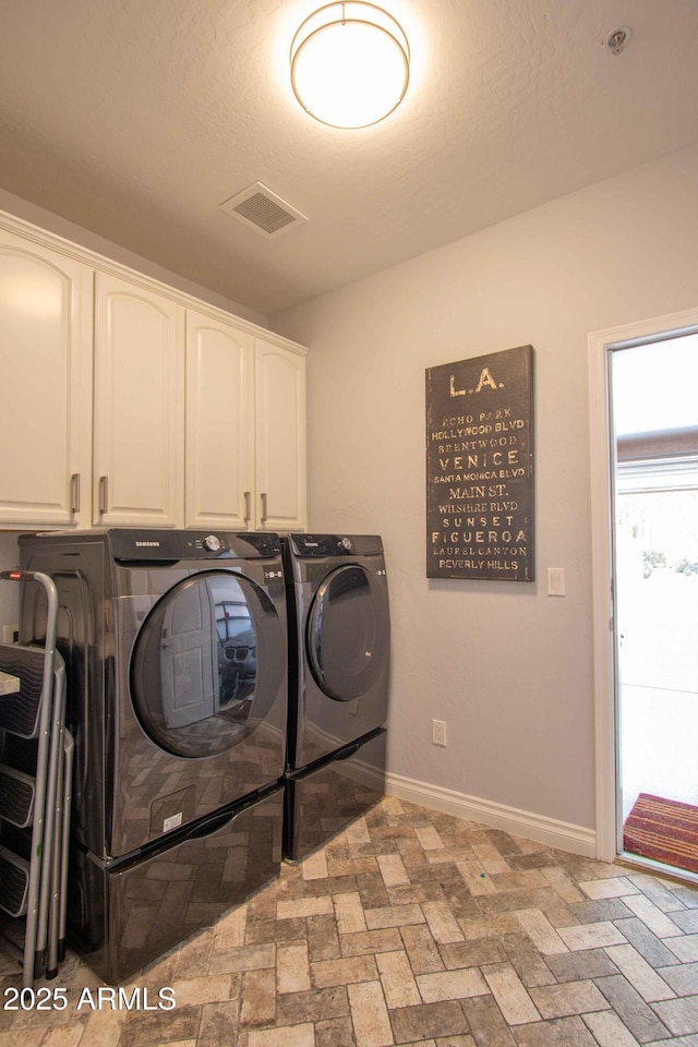 10655 N 9th St Unit 112, Phoenix, AZ 85020 - laundry area with cabinet space, washing machine and clothes dryer, and brick patterned floors