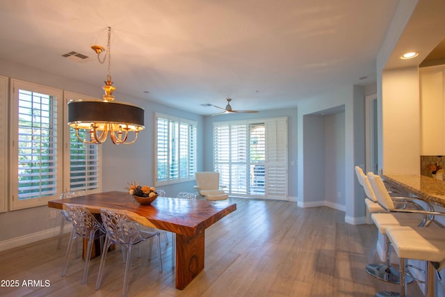 10655 N 9th St Unit 112, Phoenix, AZ 85020 - dining area with wood finished floors, recessed lighting, a chandelier, and a ceiling fan