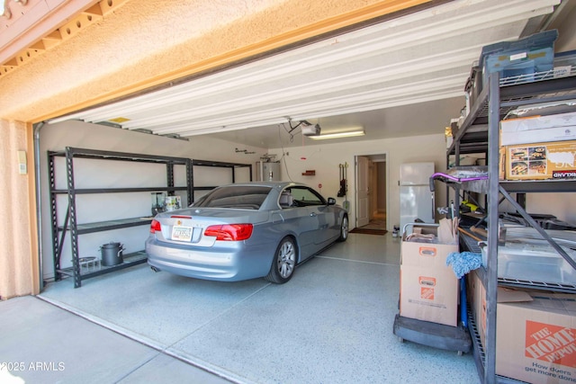 10655 N 9th St Unit 112, Phoenix, AZ 85020 - garage with freestanding refrigerator, a garage door opener, and water heater