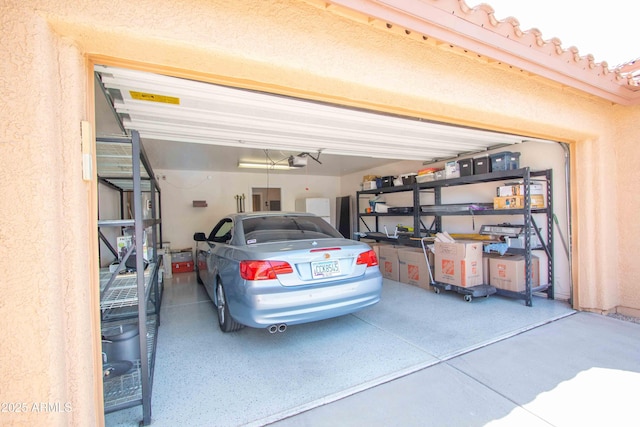 10655 N 9th St Unit 112, Phoenix, AZ 85020 - garage featuring a garage door opener and driveway