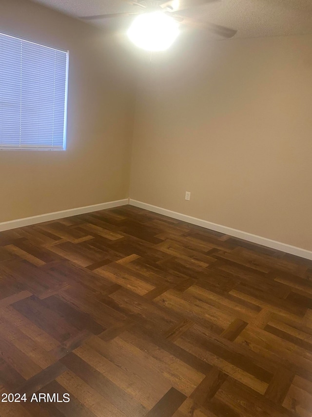 empty room with dark parquet flooring