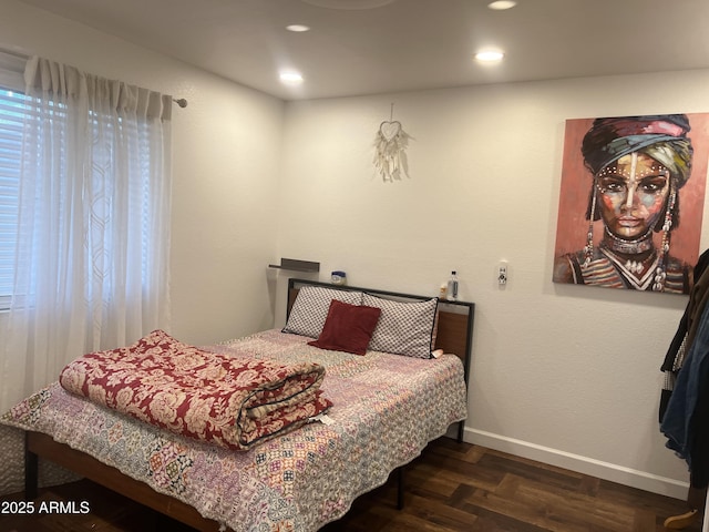 bedroom with dark parquet flooring