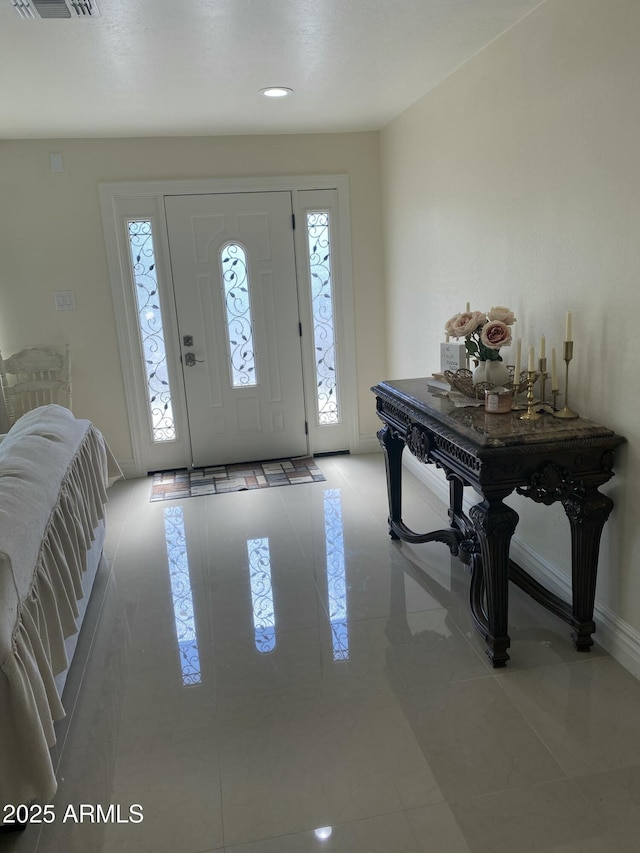 tiled foyer entrance with recessed lighting, visible vents, and baseboards