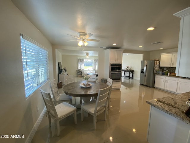 dining room with baseboards, visible vents, a ceiling fan, and recessed lighting