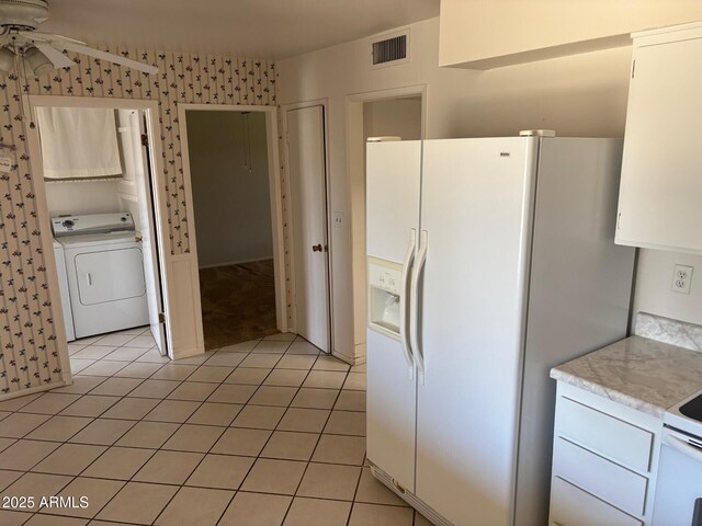 13603 N 111th Ave, Sun City, AZ 85351 - kitchen with washer / dryer, white fridge with ice dispenser, light countertops, a ceiling fan, and light tile patterned floors