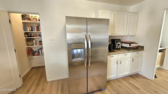 1520 W Encanto Blvd, Phoenix, AZ 85007 - kitchen with white cabinets, light wood finished floors, baseboards, and stainless steel fridge with ice dispenser