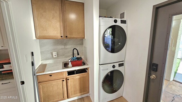 1520 W Encanto Blvd, Phoenix, AZ 85007 - washroom featuring visible vents, stacked washing maching and dryer, laundry area, and a sink