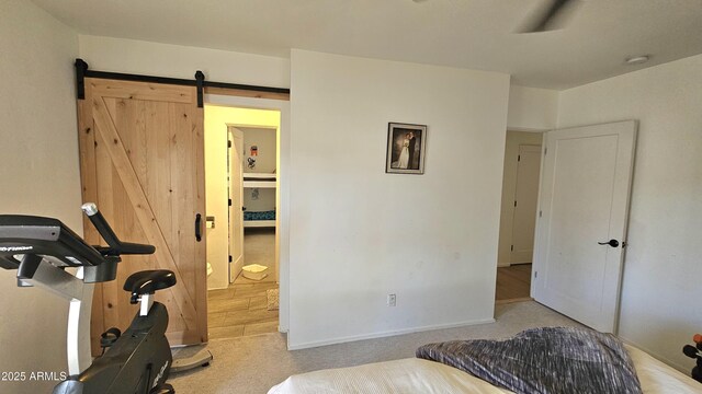 1520 W Encanto Blvd, Phoenix, AZ 85007 - bedroom featuring a barn door, carpet floors, and baseboards