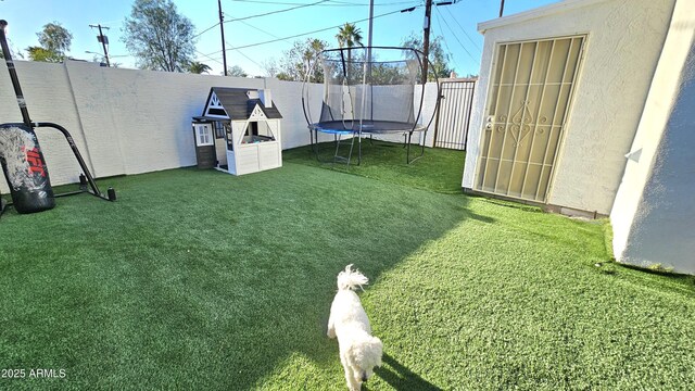 1520 W Encanto Blvd, Phoenix, AZ 85007 - view of yard featuring a fenced backyard and a trampoline