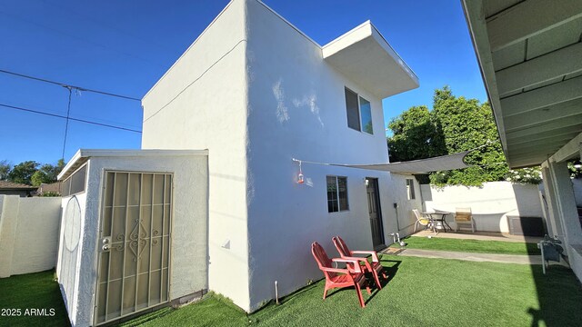 1520 W Encanto Blvd, Phoenix, AZ 85007 - rear view of property featuring an outbuilding, fence, a patio area, a lawn, and stucco siding
