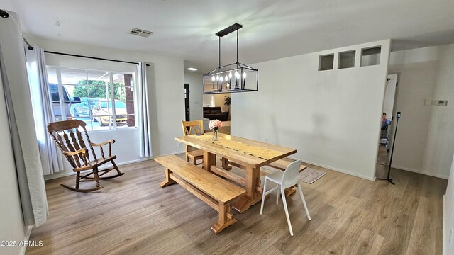 1520 W Encanto Blvd, Phoenix, AZ 85007 - dining area with baseboards, light wood-style flooring, visible vents, and a chandelier