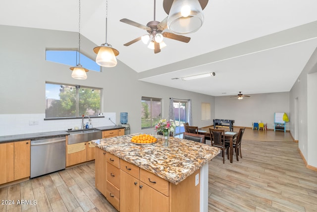 kitchen with a sink, light wood-style flooring, stainless steel dishwasher, and a center island