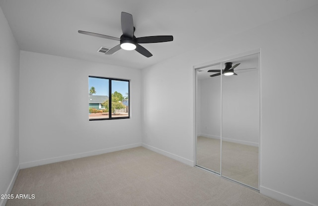 unfurnished bedroom with a closet, baseboards, visible vents, and carpet floors