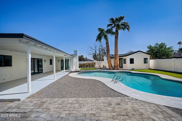 view of swimming pool with a patio area, a fenced in pool, and a fenced backyard