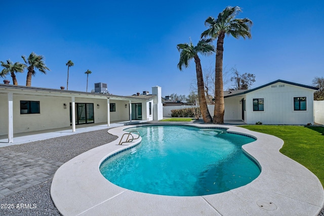 view of swimming pool with a fenced in pool, a patio, a yard, and central AC unit