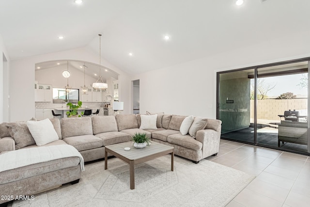 living room with light tile patterned floors, a chandelier, high vaulted ceiling, and recessed lighting