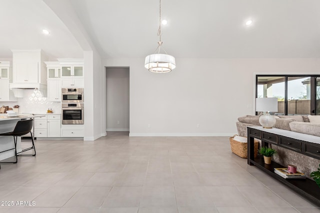 interior space featuring recessed lighting and baseboards