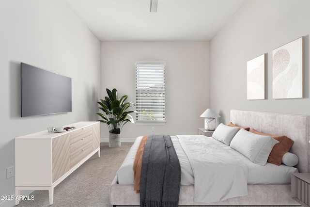 bedroom featuring light colored carpet and baseboards