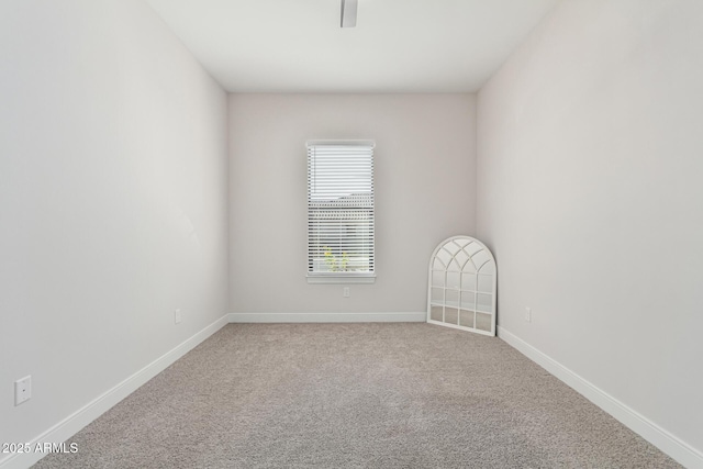 carpeted spare room with baseboards