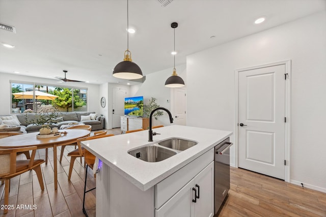 2628 S Voyager Dr Unit 104, Gilbert, AZ 85295 - kitchen with a sink, open floor plan, light wood-style floors, dishwasher, and pendant lighting