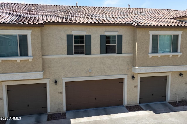 2628 S Voyager Dr Unit 104, Gilbert, AZ 85295 - view of front of property with a garage, stucco siding, and a tile roof