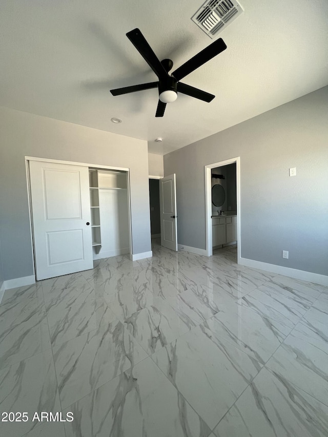 3767 N 363rd Ave, Tonopah, AZ 85354 - unfurnished bedroom featuring a closet, light marble finish floors, and a ceiling fan
