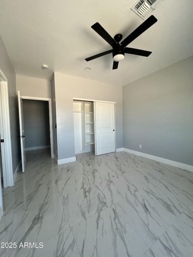 3767 N 363rd Ave, Tonopah, AZ 85354 - unfurnished bedroom featuring a closet, marble look tiles, and ceiling fan