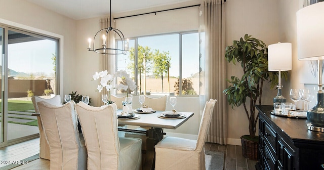 dining area with hardwood / wood-style floors and an inviting chandelier