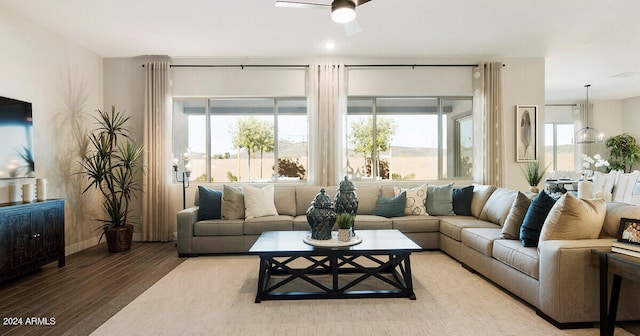 living room featuring hardwood / wood-style floors and ceiling fan