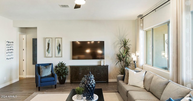 living room featuring hardwood / wood-style floors and ceiling fan