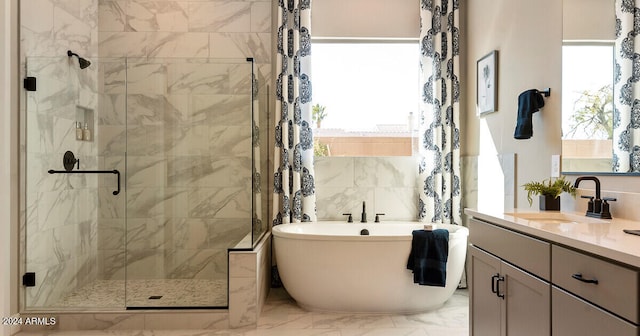 bathroom with oversized vanity, tile walls, tile floors, and a wealth of natural light