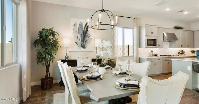 dining room with a notable chandelier and dark hardwood / wood-style flooring