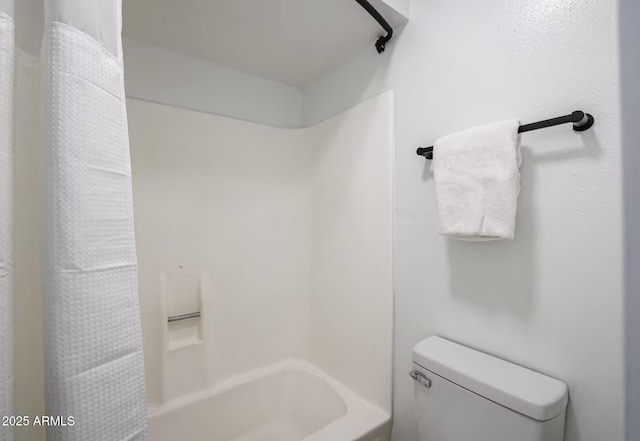 full bath with shower / bath combo with shower curtain and toilet